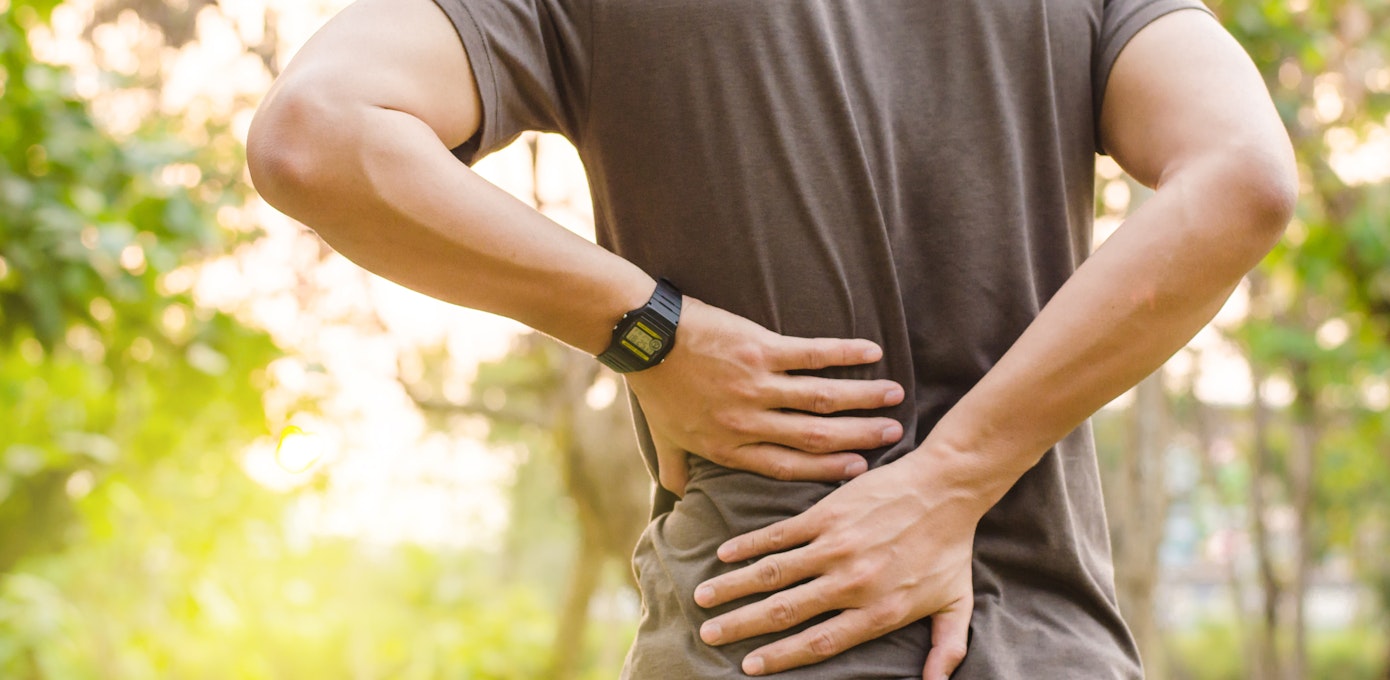 An image depicting a person suffering from lower back pain symptoms
