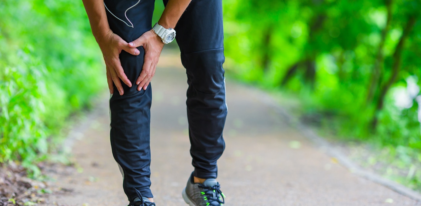 An image depicting a person suffering from pain in the front of the knee symptoms
