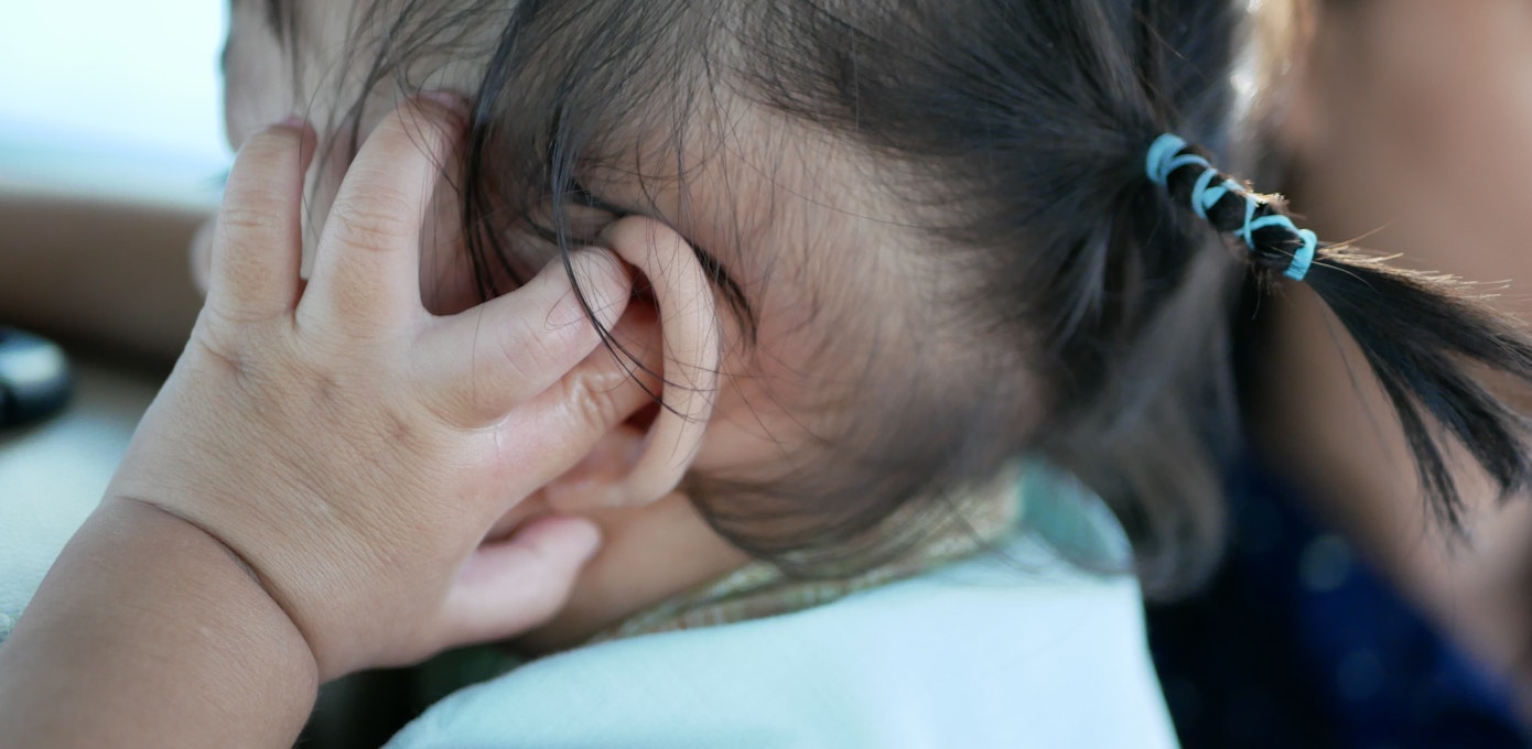 An image depicting a person suffering from unilateral ear itch symptoms