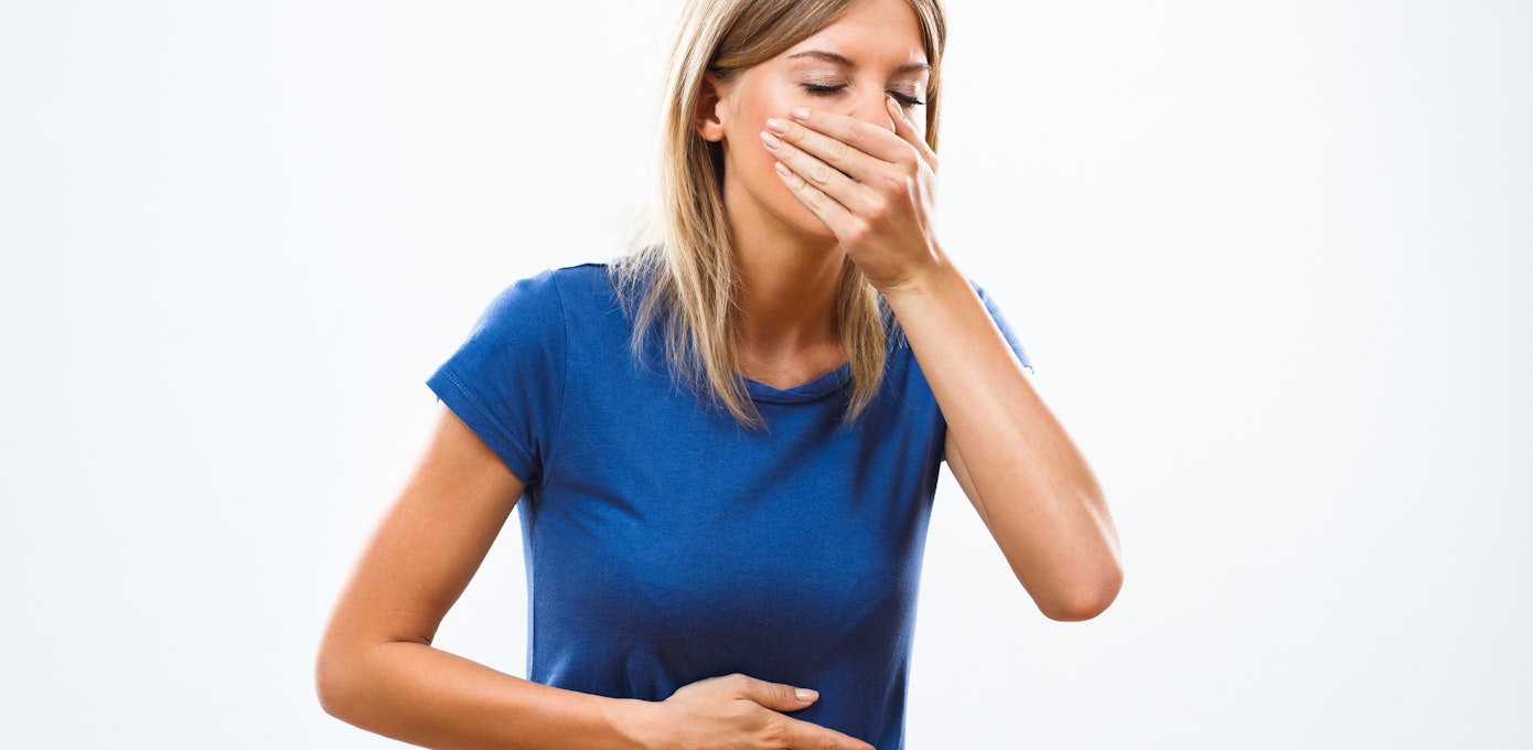 An image depicting a person suffering from vomiting with streaks of blood symptoms